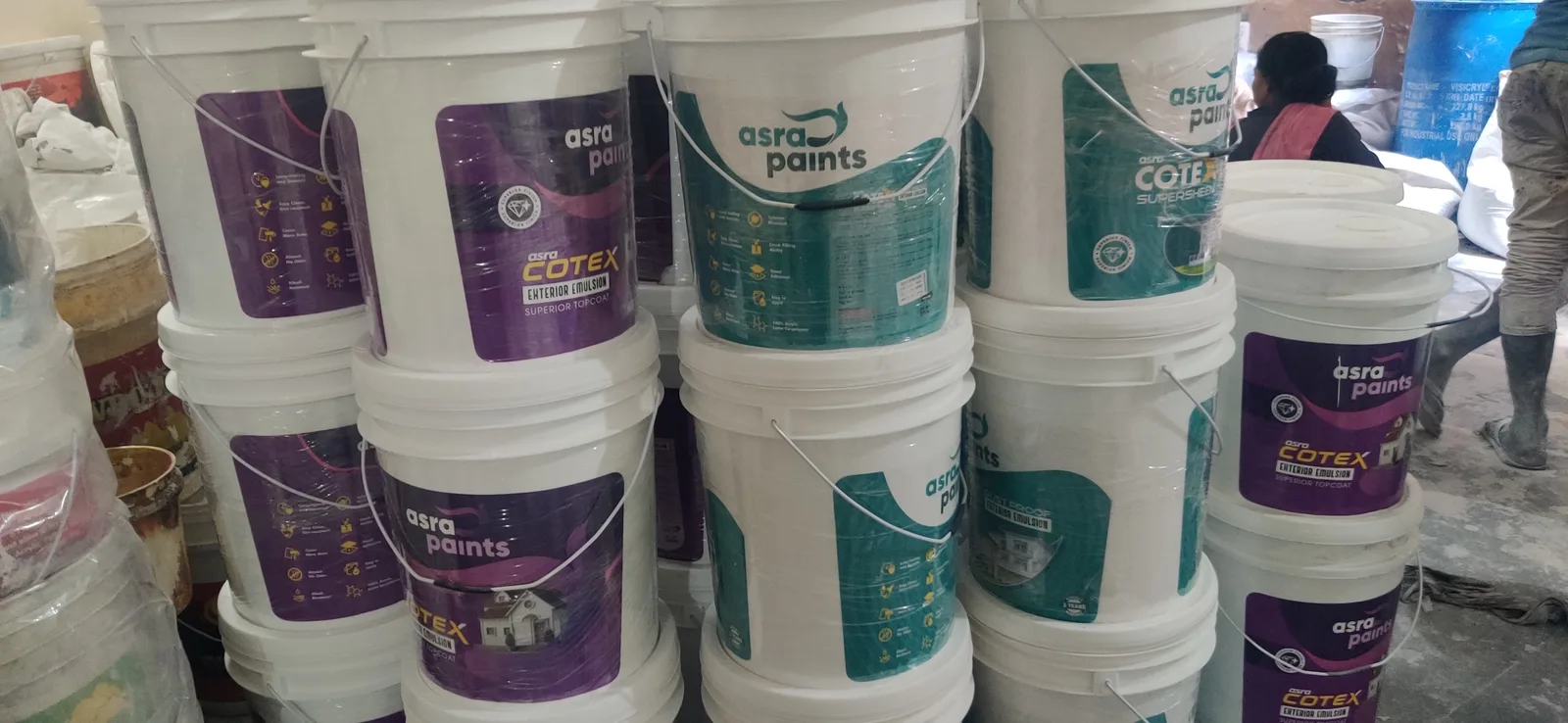 Stacked Asra Cotex emulsion buckets in the Sahibabad warehouse